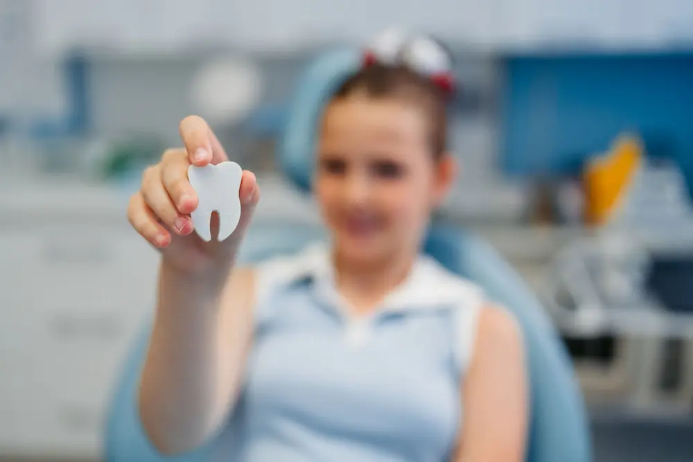 Demonstration of proper handling for an avulsed or knocked-out tooth before emergency dental care